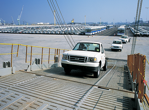 Cars loading into a cargo ship in Thailand